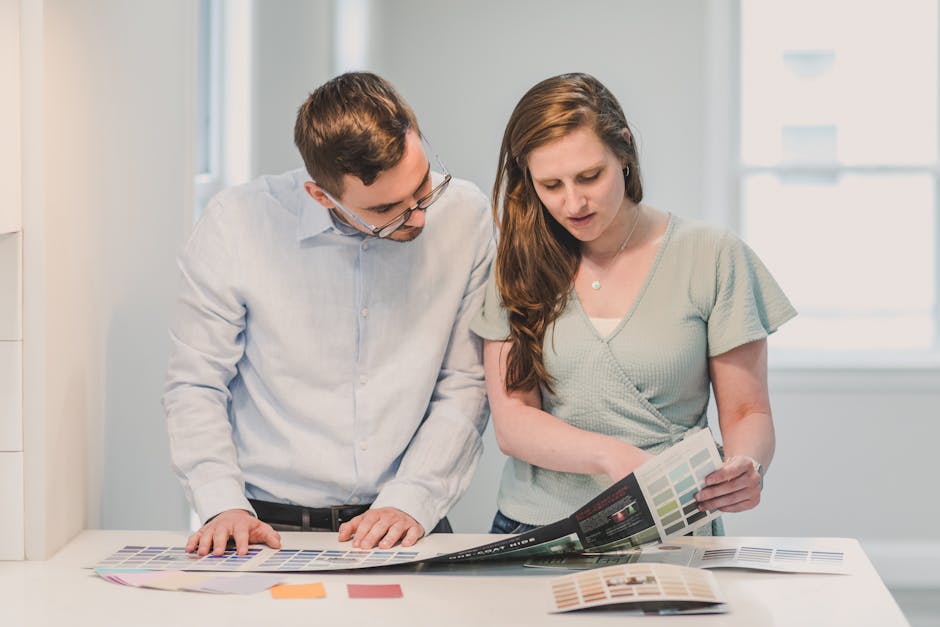 A man and a woman reviewing design samples together in an indoor setting.