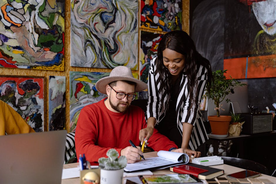 A diverse team working together on an art project in a creative office environment.